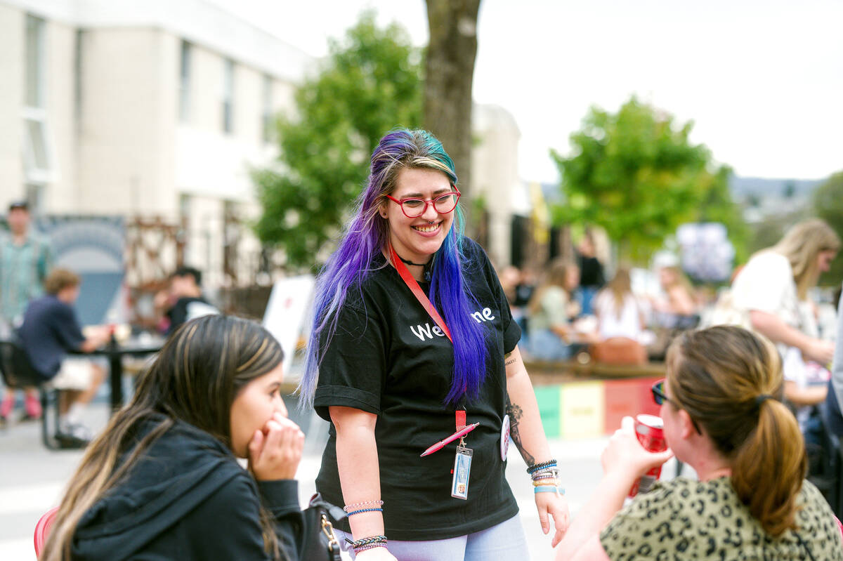 university student help staff with rainbow coloured hair